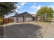 Wide driveway leading to this home with a gray exterior and a three-car garage at 20464 E Bronco Dr, Queen Creek, AZ 85142
