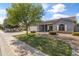 Inviting single-story home featuring a landscaped yard, covered porch, and gray siding with stone accents at 20464 E Bronco Dr, Queen Creek, AZ 85142
