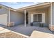Cozy front porch with a welcome bench, decorative stone accents, and gray siding at 20464 E Bronco Dr, Queen Creek, AZ 85142