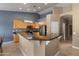 Modern kitchen featuring granite countertops, maple cabinets, and a breakfast bar overlooking the dining area at 20464 E Bronco Dr, Queen Creek, AZ 85142