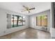 Bright bedroom featuring neutral paint, tile floors, a ceiling fan, and large windows providing natural light at 2064 S Farnsworth Dr # 43, Mesa, AZ 85209
