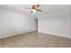 Well-lit bedroom with neutral tile flooring, a ceiling fan, and a closet for ample storage space at 2064 S Farnsworth Dr # 43, Mesa, AZ 85209