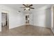 Neutral bedroom with tile flooring, ceiling fan, view into bathroom and laundry area at 2064 S Farnsworth Dr # 43, Mesa, AZ 85209