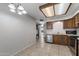 Open dining area with a chandelier, tiled flooring, and a view into the adjacent kitchen with stainless appliances at 2064 S Farnsworth Dr # 43, Mesa, AZ 85209