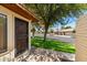 Exterior view of a home with desert landscaping, mature trees, and a sidewalk, offering a welcoming curb appeal at 2064 S Farnsworth Dr # 43, Mesa, AZ 85209