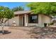 Charming single-story home featuring a cozy front porch with a brick accent wall and well-maintained landscaping at 2064 S Farnsworth Dr # 43, Mesa, AZ 85209
