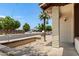 Inviting front porch with a brick accent wall and decorative light fixture, perfect for enjoying the neighborhood view at 2064 S Farnsworth Dr # 43, Mesa, AZ 85209