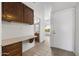 Functional hallway area with a built-in desk, ample cabinet space, and access to other rooms in the home at 2064 S Farnsworth Dr # 43, Mesa, AZ 85209