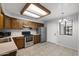 Functional kitchen featuring stainless appliances, wood cabinets, tiled flooring, and a well-lit ceiling fixture at 2064 S Farnsworth Dr # 43, Mesa, AZ 85209