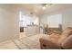 A cozy living room includes an open floor plan to the kitchen, a couch, and a neutral decor at 2117 E Saltsage Dr, Phoenix, AZ 85048