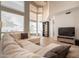 Comfortable living room with large windows, entertainment center, and wood flooring at 2117 E Saltsage Dr, Phoenix, AZ 85048
