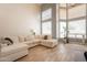 This light-filled living room is large with high ceilings and a comfortable sectional sofa at 2117 E Saltsage Dr, Phoenix, AZ 85048