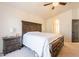 Bright main bedroom with neutral walls, ceiling fan, ensuite and large wood furniture set at 2117 E Saltsage Dr, Phoenix, AZ 85048