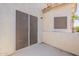 Cozy outdoor patio with concrete floor, exterior walls, and sliding screen doors at 2117 E Saltsage Dr, Phoenix, AZ 85048