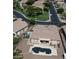 Aerial view of a property featuring a private pool, covered patio, and landscaped backyard at 2122 N Stapley Dr, Mesa, AZ 85203