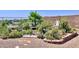 Lush backyard garden with mature landscaping and decorative accents with rock bed at 2122 N Stapley Dr, Mesa, AZ 85203