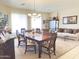 Bright dining room showcasing a wooden table, plush seating, and seamless access to the living area at 2122 N Stapley Dr, Mesa, AZ 85203