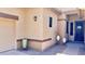 Inviting front porch showcasing decorative pots, brick pavers, and a stylish glass-paneled front door at 2122 N Stapley Dr, Mesa, AZ 85203