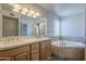 Bathroom features double sinks, granite countertops, soaking tub and tile surround at 2340 W Myrtle Dr, Chandler, AZ 85248