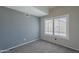 Cozy bedroom with neutral tones, a window with shutters, and soft carpeting at 2340 W Myrtle Dr, Chandler, AZ 85248
