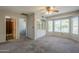 Inviting bedroom featuring built-in shelving, neutral colors, and a ceiling fan at 2340 W Myrtle Dr, Chandler, AZ 85248