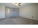 Modern bedroom featuring a sliding barn door, neutral colors, carpet and a ceiling fan at 2340 W Myrtle Dr, Chandler, AZ 85248