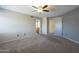 Relaxing bedroom with a ceiling fan, sliding barn door to an ensuite bathroom at 2340 W Myrtle Dr, Chandler, AZ 85248