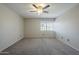 Spacious bedroom features neutral tones, a ceiling fan, and a window for natural light at 2340 W Myrtle Dr, Chandler, AZ 85248