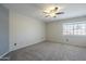 Spacious bedroom with a ceiling fan and ample natural light from a window at 2340 W Myrtle Dr, Chandler, AZ 85248