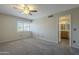 Cozy bedroom featuring a ceiling fan, carpet, a window, and an ensuite bathroom at 2340 W Myrtle Dr, Chandler, AZ 85248