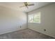 Cozy bedroom features neutral tones, a ceiling fan, and a window for natural light at 2340 W Myrtle Dr, Chandler, AZ 85248
