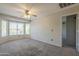 Bright bedroom featuring a ceiling fan, carpet, and a bay window at 2340 W Myrtle Dr, Chandler, AZ 85248