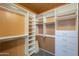 Custom walk-in closet with built in shelving and drawers, and carpet floors at 2340 W Myrtle Dr, Chandler, AZ 85248