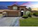 Charming two-story home featuring a well-manicured lawn, a two car garage and a terra cotta roof at 2340 W Myrtle Dr, Chandler, AZ 85248