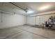 Spacious garage with neutral walls, concrete floor, and convenient interior access doors at 2340 W Myrtle Dr, Chandler, AZ 85248