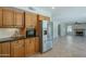Updated kitchen features wood cabinets, granite countertops, stainless steel appliances, and tile floors at 2340 W Myrtle Dr, Chandler, AZ 85248
