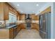 This kitchen boasts stainless appliances, granite countertops, tile backsplash, and wood cabinets at 2340 W Myrtle Dr, Chandler, AZ 85248