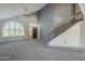 Bright living room with high ceilings, ample natural light, and neutral carpeting, perfect for entertaining at 2340 W Myrtle Dr, Chandler, AZ 85248