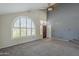 Bright living room with high ceilings, ample natural light, and neutral carpeting, perfect for entertaining at 2340 W Myrtle Dr, Chandler, AZ 85248