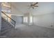 Bright living room featuring a high ceiling, large windows with shutters, and a staircase at 2340 W Myrtle Dr, Chandler, AZ 85248