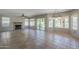 Spacious living room boasts a fireplace, tile flooring, and sliding glass doors to the backyard at 2340 W Myrtle Dr, Chandler, AZ 85248