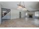 Open living area features tile flooring, a cozy fireplace, and a staircase at 2340 W Myrtle Dr, Chandler, AZ 85248