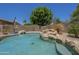 Backyard pool has rock accents and lush landscaping creating a private retreat perfect for relaxing and entertaining at 2340 W Myrtle Dr, Chandler, AZ 85248