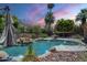 Backyard view of a gorgeous pool area with stone accents, lush trees, and a covered patio for relaxing at 2340 W Myrtle Dr, Chandler, AZ 85248