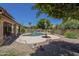 Backyard pool offers a tranquil escape with rock features, desert landscape, and ample space for outdoor living at 2340 W Myrtle Dr, Chandler, AZ 85248