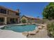 Landscaped backyard features a pool with rock accents, creating a serene oasis perfect for relaxation and outdoor enjoyment at 2340 W Myrtle Dr, Chandler, AZ 85248