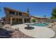 Backyard pool featuring a rock surround and patio with outdoor seating area, ideal for outdoor entertaining at 2340 W Myrtle Dr, Chandler, AZ 85248