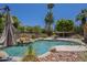 Backyard pool features rock accents, desert landscaping, and a tanning ledge, perfect for relaxing in the sun at 2340 W Myrtle Dr, Chandler, AZ 85248