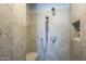 The shower features decorative shower tile, river rock floor and built in bench at 2340 W Myrtle Dr, Chandler, AZ 85248