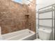Cozy bathroom with tiled shower over tub, shelving, and updated fixtures at 24013 N 165Th Ave, Surprise, AZ 85387